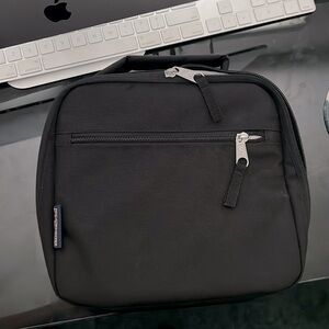 Jansport black lunch bag with 2 pockets, main handle, & in excellent condition